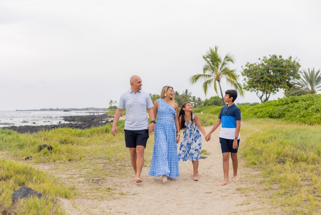 Noura and her family walking along the shore on a family trip